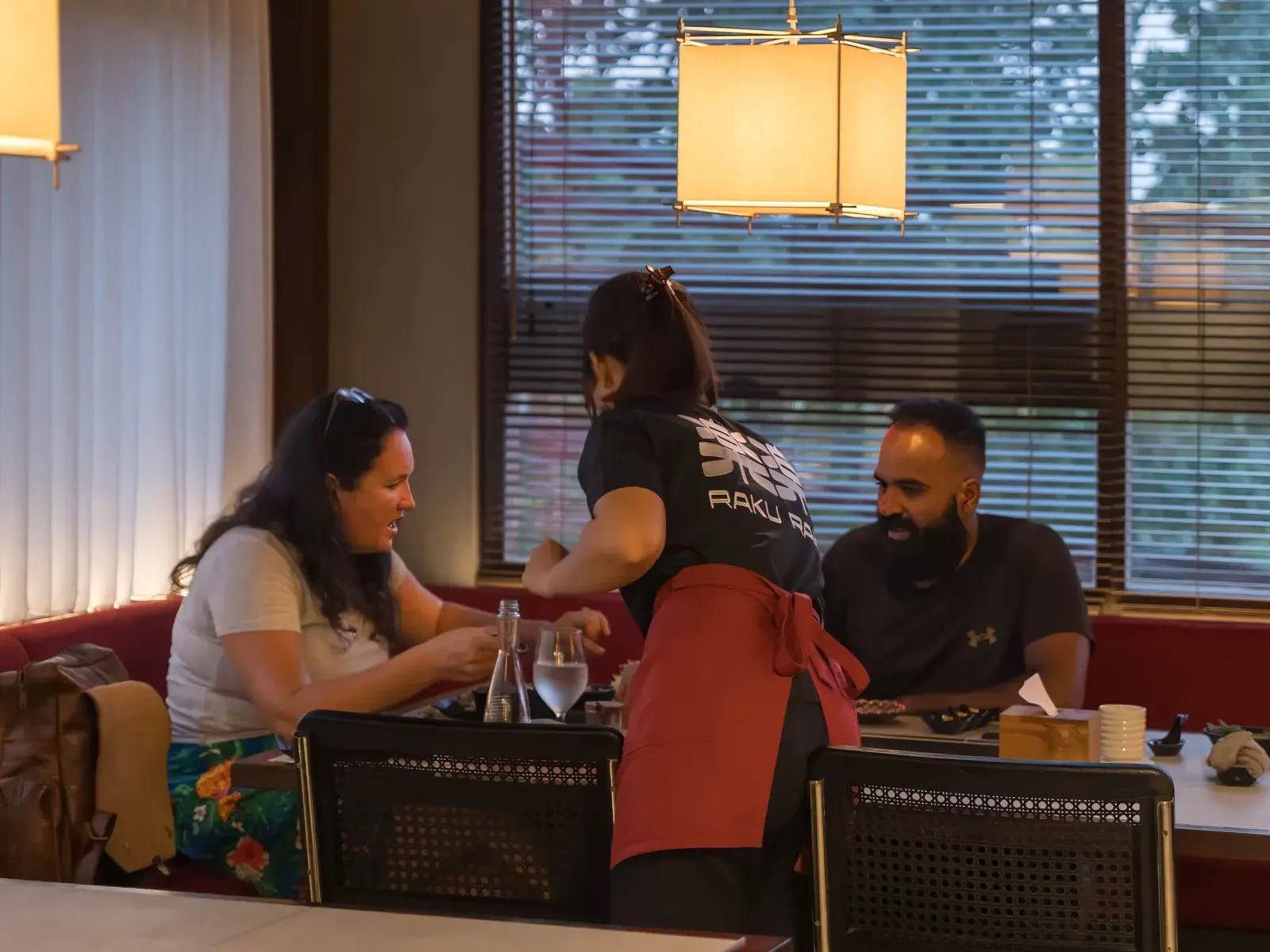Friends gathered around the grill table, one of the best japanese restaurants Ubud offers for groups.