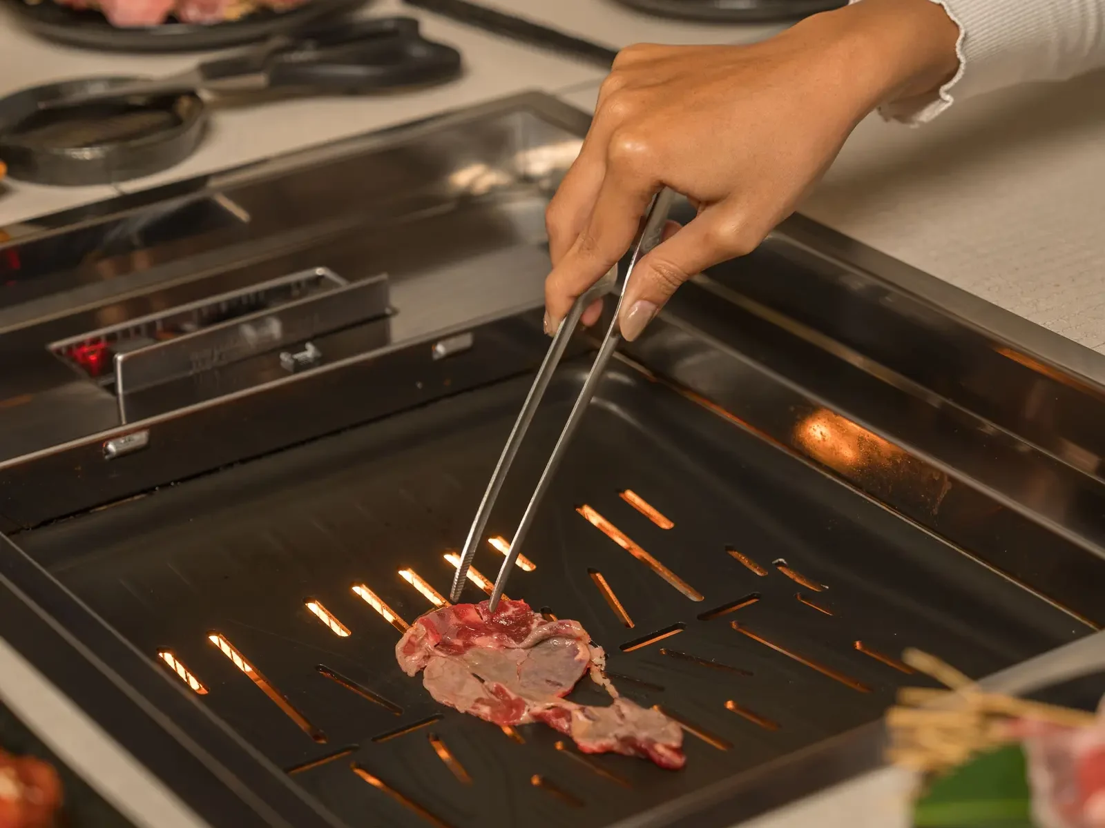 Grilling premium cuts tableside, capturing the essence of yakiniku Ubud restaurant.