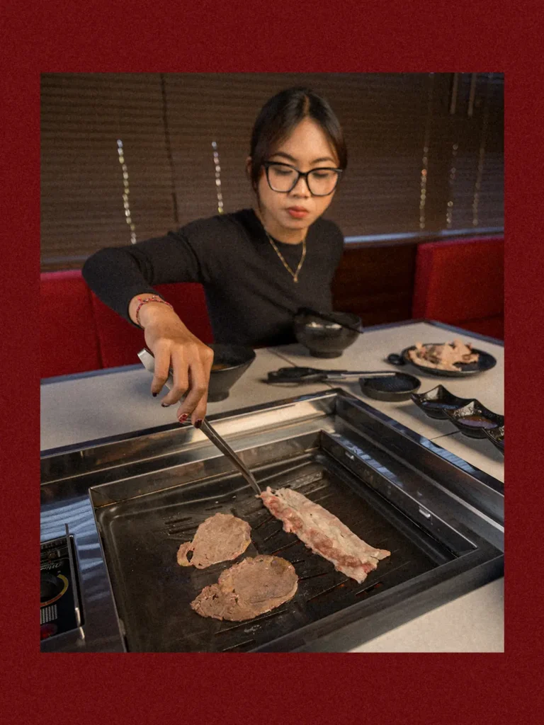 Premium wagyu beef grilling tableside at Raku Raku, the centerpiece of the comfort food menu