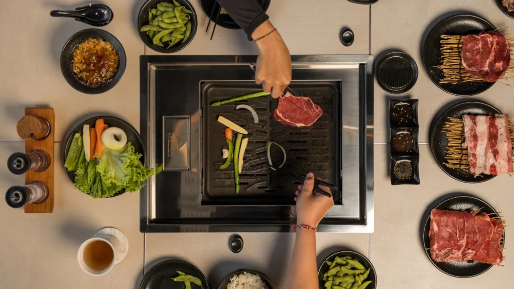 Japanese food Ubud served at Raku Raku Yakiniku, featuring grilled meat and traditional side dishes