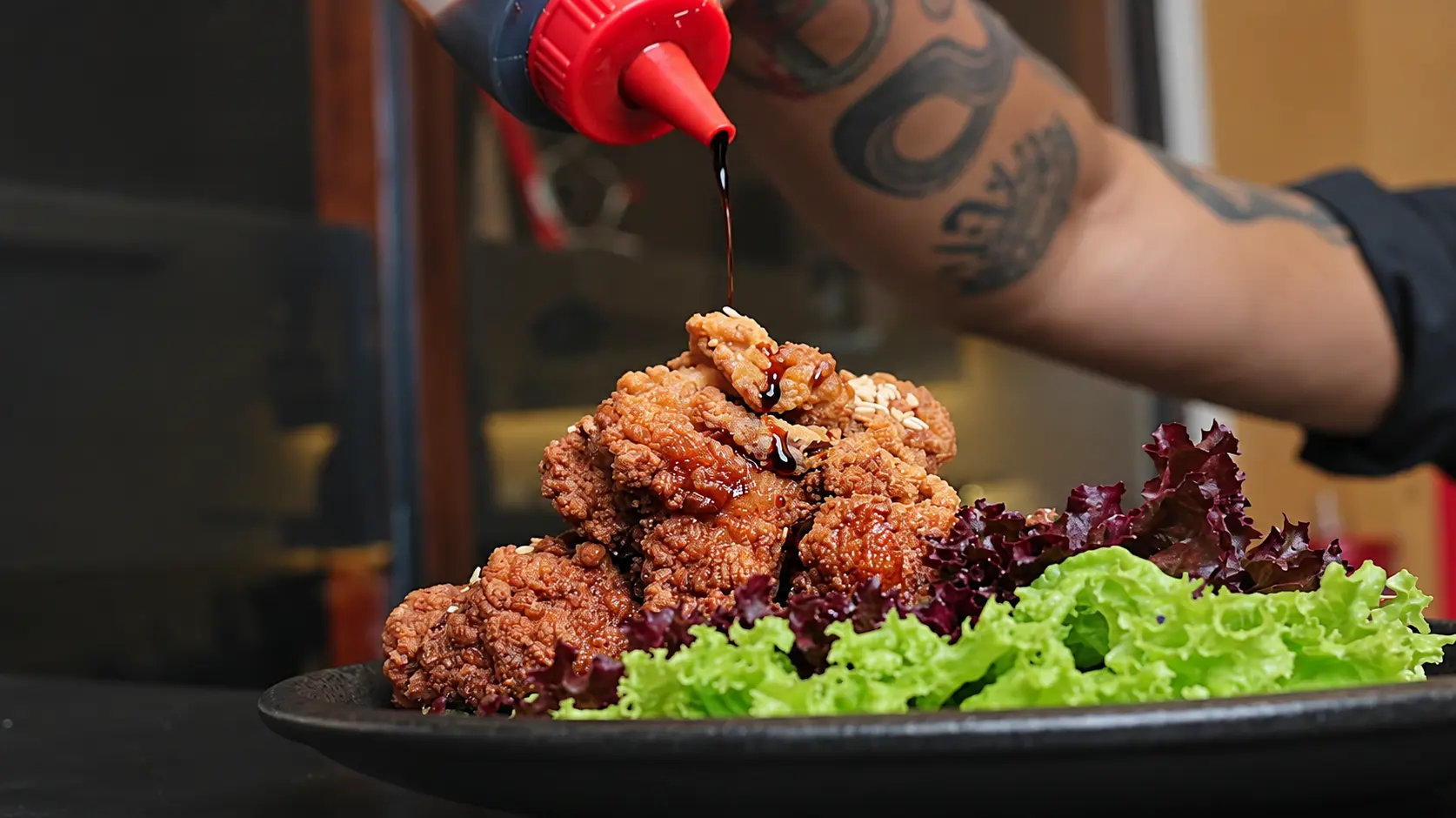 Japanese-inspired crispy chicken being finished with sauce using Sustainable Japanese Ingredients Ubud