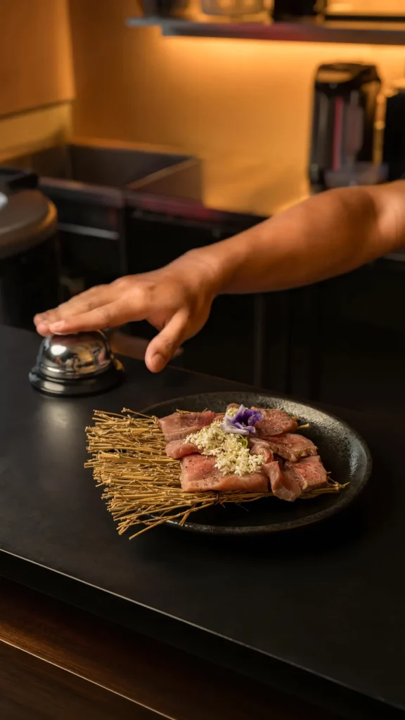 Spread of grilled meats and sides for a group at Raku Raku Yakiniku